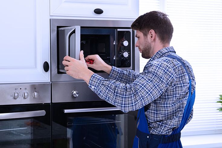 Technician repairing stove
